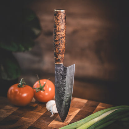 Handmade Damascus steel kitchen knife made by hand in our factory in Finland. The Damascus steel has 37 layers of steel. Comes with a handle made from stained curly birch and a handmade leather sheath.