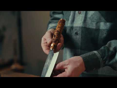 Roselli's handcrafted Santoku kitchen knife in high-carbon steel (UHC steel) with a stained curly birch handle. Delivered with a handmade leather sheath.